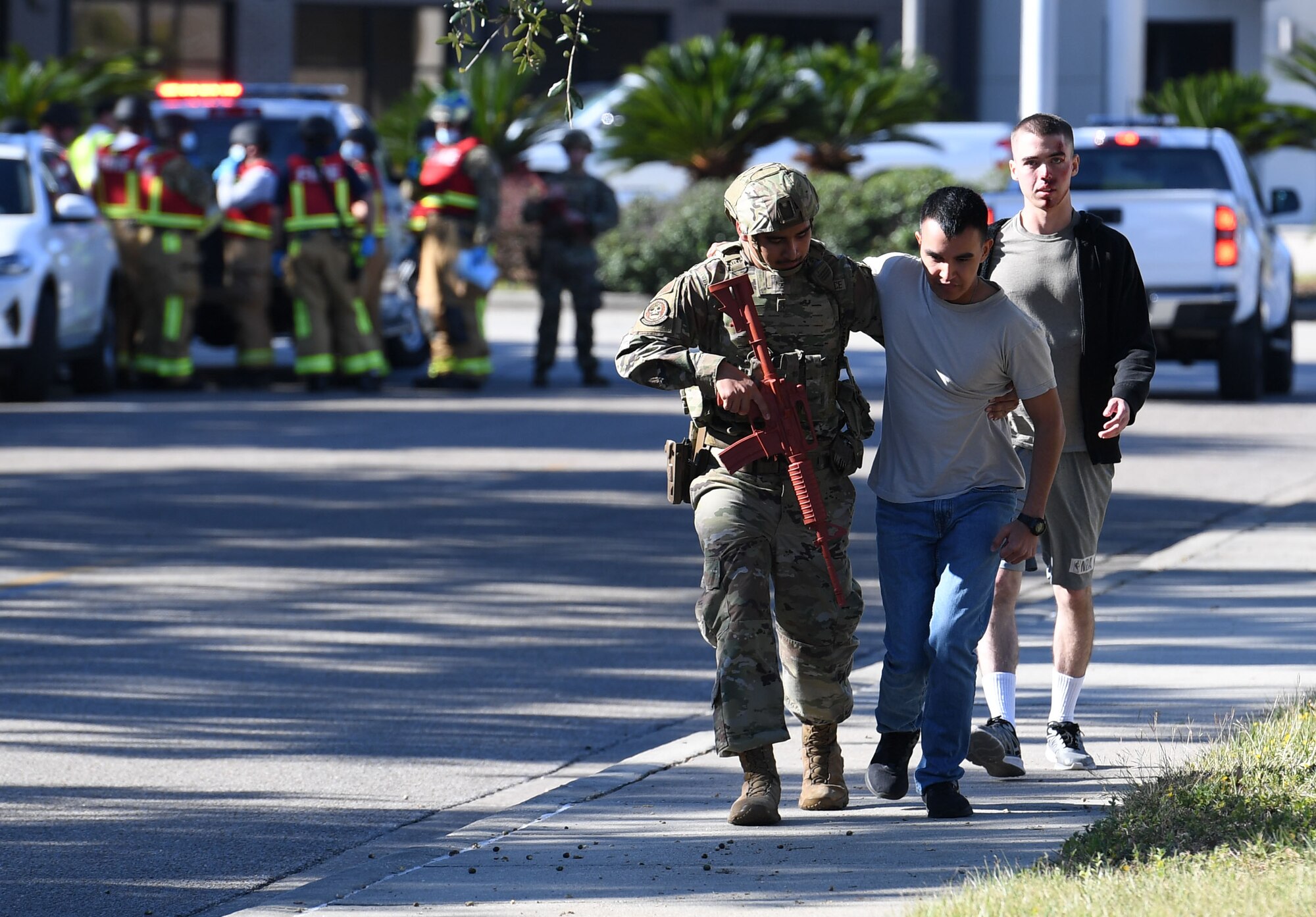 U.S. Air Force Airman 1st Class Angel Silva, 81st Security Forces Squadron entry controller, escorts Airman 1st Class Danny Cornel and Airman Tommy Williams, 338th Training Squadron students who portrays victims, to the triage area during an active shooter exercise outside the Levitow Training Support Facility at Keesler Air Force Base, Mississippi, Oct. 20, 2022