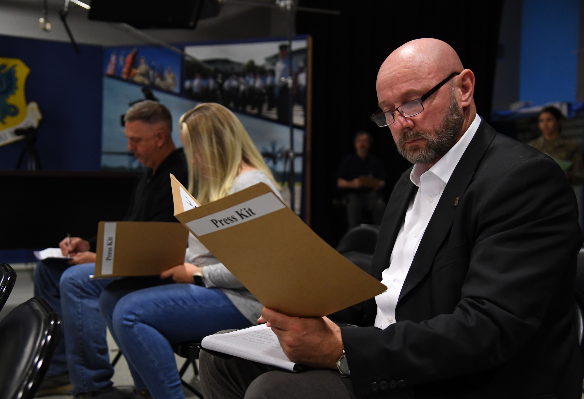 Scott Lucas, 81st Training Wing operation/contingency plans and programs chief, reviews a press kit during a press conference inside Wall Studio during an active shooter exercise inside the Levitow Training Support Facility at Keesler Air Force Base, Mississippi, Oct. 20, 2022. The scenario included two active duty Air Force members who simulated opening fire in order to test the base's ability to respond to and recover from a mass casualty event. (U.S. Air Force photo by Kemberly Groue)
