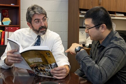 Richard Baughman and Jiho Lee, U.S. Army Financial Management Command Audit Response Center accountants, discuss the U.S. Army’s Annual Financial Report at the Maj. Gen. Emmett J. Bean Federal Center in Indianapolis Oct. 19, 2022. Baughman was awarded the 2021 Louis Dellamonica Award for Outstanding U.S. Army Materiel Command Personnel of the Year. (U.S. Army photo by Mark R. W. Orders-Woempner)