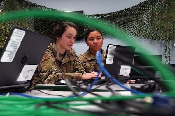 Air Force 2nd Lieutenant Alexis Shirley and 2nd Lieutenant Trisha Crisp, 333rd Training Squadron cyber warfare officers, complete cyber tasks in cyber escape room inside Stennis Hall, at Keesler Air Force Base, Mississippi, November 10, 2021 (U.S. Air Force/Seth Haddix)