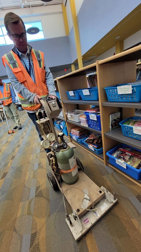 USACE St. Louis District Formerly Utilized Sites Remedial Action Program contractor collects measurements from the Jana Elementary School library. Sampling began Monday, Oct. 24, and preliminary results will be available within two weeks. (US Army Photo by JP Rebello)