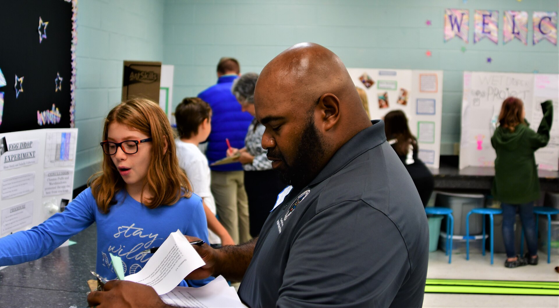 IMAGE: Volunteer judge Merrel Grant discusses a STEM project with Bowling Green Elementary School fifth-grader Marissa Moore during a STEM Fair at the school on Oct. 13.