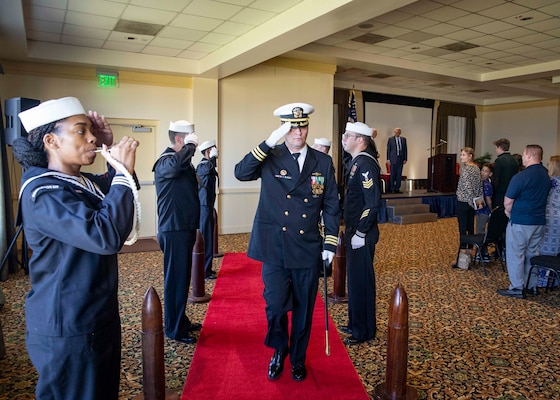 Capt. Christopher Holland, commanding officer of the Los Angeles-class attack submarine USS Boise (SSN 764), renders a salute to sideboys during a change of command ceremony onboard Naval Station Norfolk, Oct. 21, 2022.