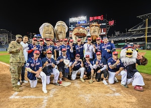 The Joint Base Andrews softball team celebrates their victory over Joint Base Myers-Henderson Hall at Nationals Park in Washington D.C., Oct. 24, 2022.
