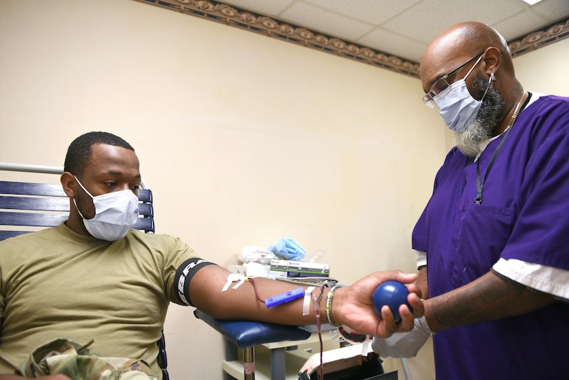 U.S. Army Spc. Sashon A. Stewart, U.S. Army Medical Department Activity McDonald Army Health Center orthopedic technician, donates blood as Robert Winfield, Naval Medical Center Portsmouth phlebotomist contractor, monitors blood flow during an Armed Services Blood Program blood drive at McDonald Army Health Center, Joint Base Langley-Eustis, Va., Oct. 19, 2022.