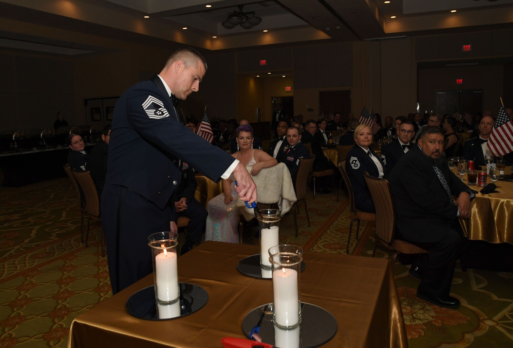 U.S. Air Force Chief Master Sgt. Robert Schlichtenmyer, 335th Training Squadron senior enlisted leader, participates in a candle lighting ceremony during the Keesler Senior Noncommissioned Officer Recognition Ceremony inside the Bay Breeze Event Center at Keesler Air Force Base, Mississippi, Oct. 21, 2022.