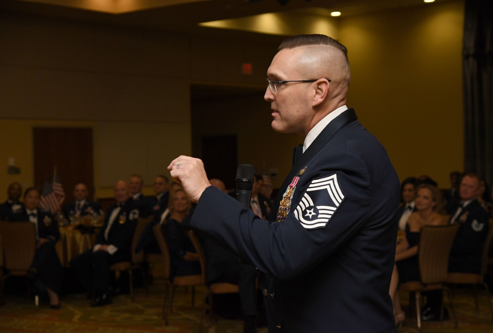 U.S. Air Force Chief Master Sgt. Brent Chadick, Chief Master Sergeant Leadership Academy instructor, Maxwell Air Force Base-Gunter Annex, Alabama, delivers remarks during the Keesler Senior Noncommissioned Officer Recognition Ceremony inside the Bay Breeze Event Center at Keesler Air Force Base, Mississippi, Oct. 21, 2022.