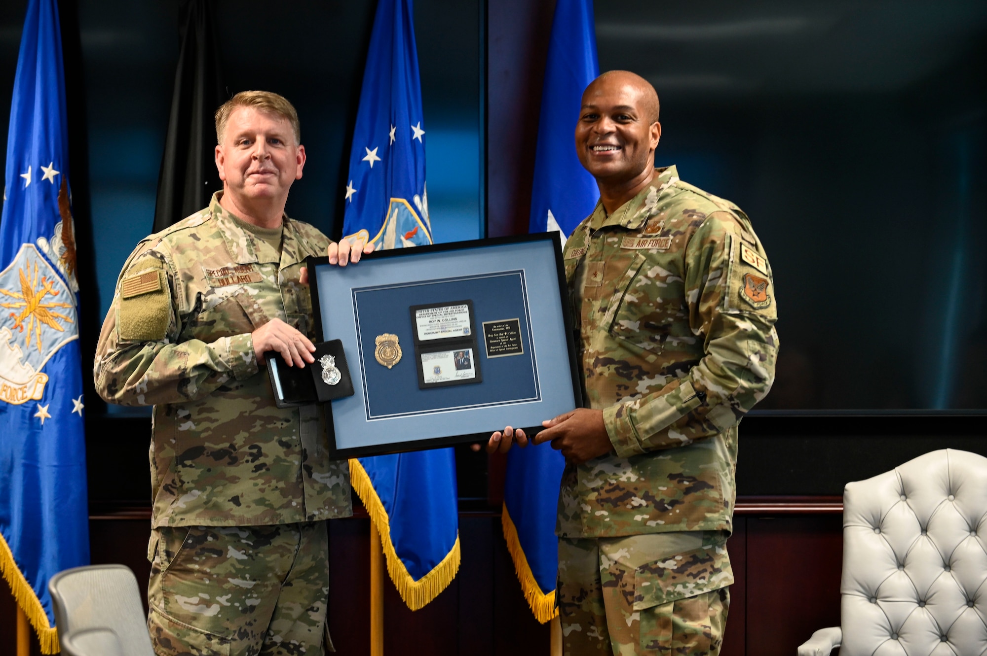 The DAF's top two law enforcement leaders, Office of Special Investigations Commander, Brig. Gen Terry L. Bullard, left, and Air Force Director of Security Forces, Brig. Gen. Roy W. Collins, exchange credentials during an honorary ceremony at OSI headquarters, in Quantico, Va., Oct. 24, 2022. In the 75 year history of OSI, less than 70 honorary credentials have been awarded. (U.S. Air Force photo by Staff Sgt. Joshua King)