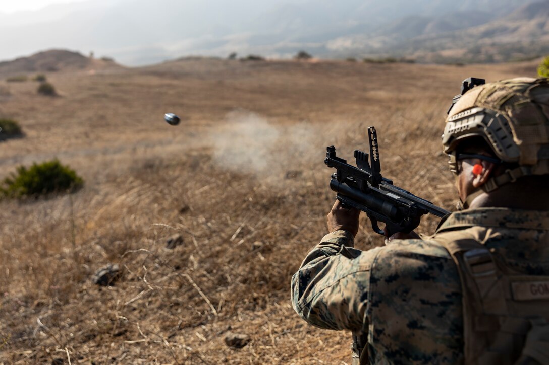 MARINE CORPS BASE CAMP PENDLETON, California (Aug. 15, 2022) - U.S. Marine Corps Lance Cpl. Gomez, a rifleman with Golf Company, Battalion Landing Team 2/4, 13th Marine Expeditionary Unit, fires his M320 Grenade Launcher on range 408, Aug. 15. Synchronizing the capabilities of the Navy-Marine Corps team multiplies the traditional influence of sea power by projecting landing forces ashore. Marines and Sailors of the 13th MEU are embarked aboard the Makin Island Amphibious Ready Group (ARG), conducting integrated training operations in U.S. 3rd Fleet. (U.S. Marine Corps photo by Cpl. Gillam)