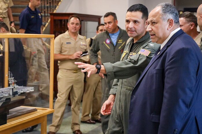 Secretary of the Navy Carlos Del Toro, right, speaks with Capt. Edgardo Moreno, Naval Aviation Schools Command’s (NASC) commanding officer, during a tour of NASC onboard Naval Air Station (NAS) Pensacola Oct. 13, 2022.