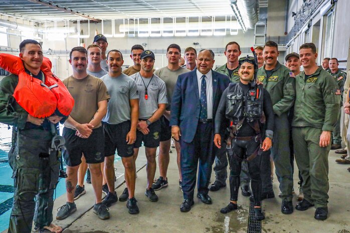 Secretary of the Navy Carlos Del Toro poses for a photograph with Sailors during a tour of the Aviation Rescue Swimmer School onboard Naval Air Station (NAS) Pensacola Oct. 13, 2022.