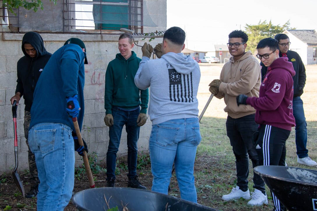 Airmen from the 97th Security Forces Squadron (SFS) help community members restore an abandoned building lot as part of their community service project with the standard resiliency course in Altus, Oklahoma Oct. 19, 2022. The Standard is a bi-annual challenge the 97th SFS puts on to encourage Airmen to meet and exceed physical and mental standards. (U.S. Air Force photo by Airman 1st Class Kari Degraffenreed)