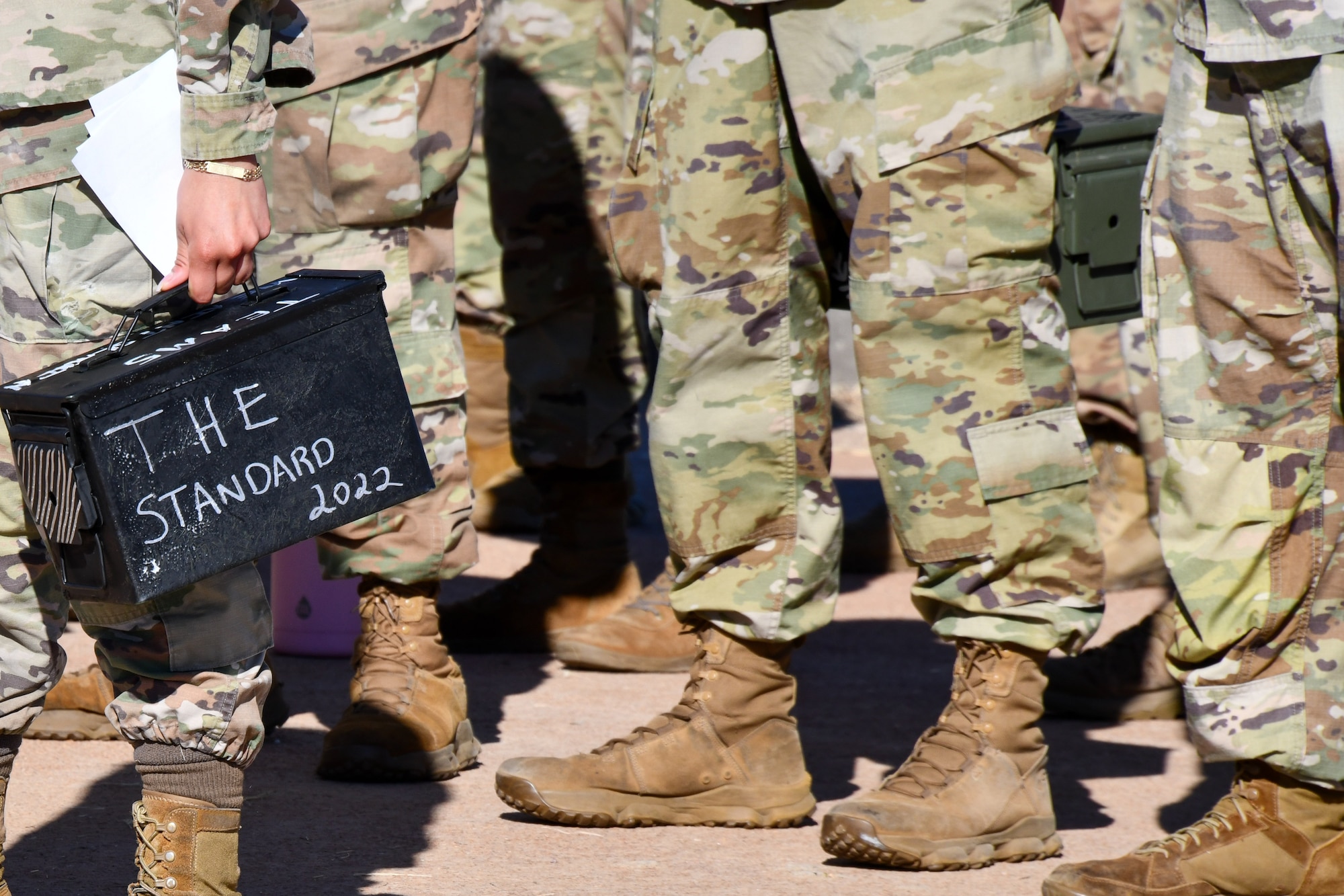An Airman participating in The Standard resiliency course organized by the 97th Security Forces Squadron holds their ammo can at Altus Air Force Base, Oklahoma, Oct. 21, 2022. At the beginning of the course, the Airmen broke up into eight teams and on the last day, members from each of the eight teams took on the task of holding the ammo can so it would never hit the ground. (U.S. Air Force photo by Airman 1st Class Kari Degraffenreed)