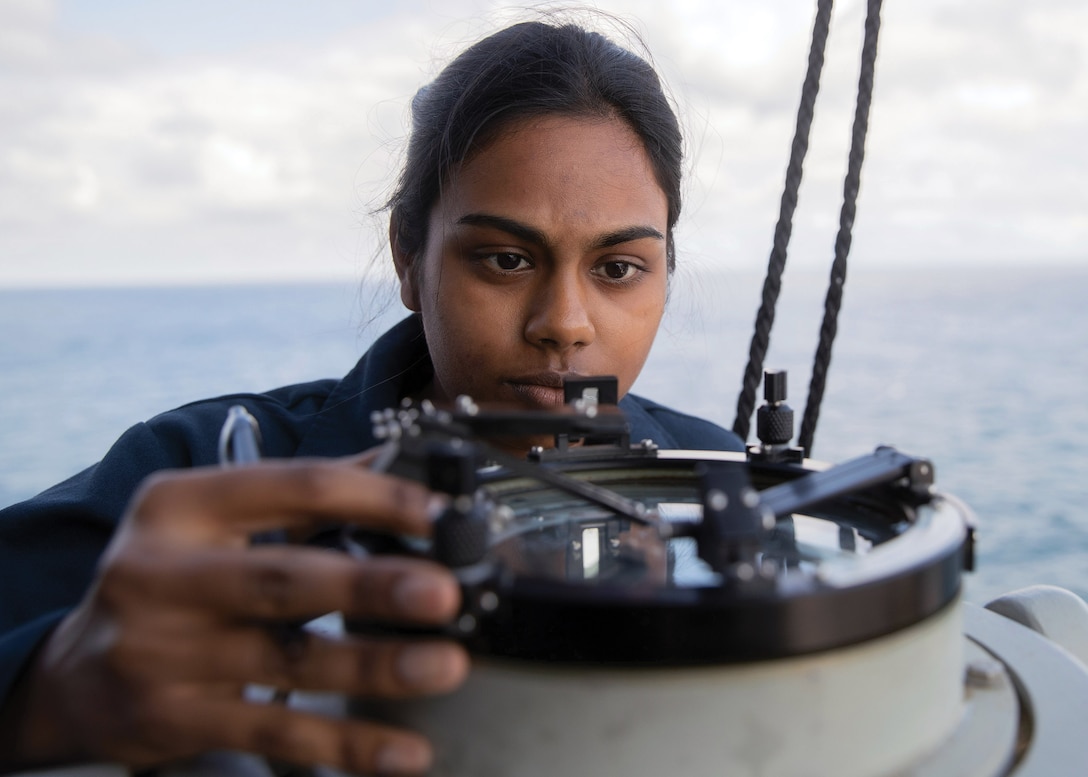 Midshipman Sayanna Pillay, assigned to U.S. Merchant Marine Academy, takes bearing with gyro repeater on USS Gerald R. Ford, underway in Atlantic Ocean, March 25, 2022 (U.S. Navy/Nolan Pennington)
