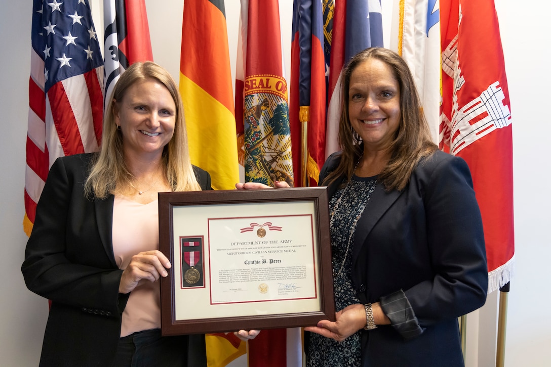 U.S. Army Col. James Booth, Jacksonville District commander, presents Cynthia B. Perez with the Department of the Army Certificate of Retirement for more than 32 years of outstanding and faithful service to the nation.  The citation cited that her accomplishments are indicative of her humility, integrity, and hard work in representing the very best of civil service.  (USACE photo by David Kimery)