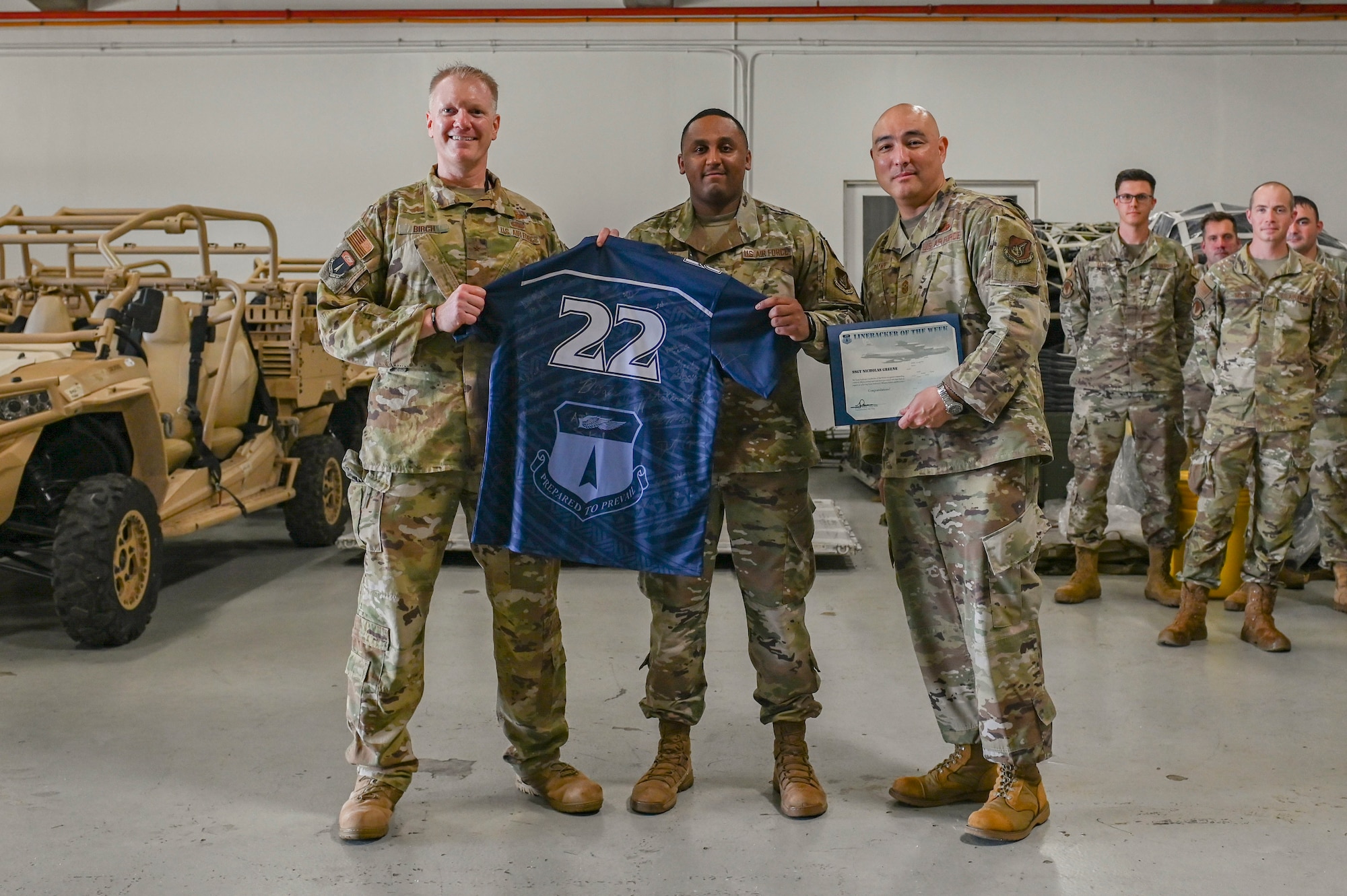 U.S. Air Force Staff Sgt. Nicholas Greene, the noncommissioned officer in charge of administration assigned to the 36th Contingency Response Squadron, receives the Linebacker of the Week Award from U.S. Air Force Brig. Gen. Paul R. Birch, 36th Wing commander, and U.S. Air Force Chief Master Sgt. John E. Payne, 36th Wing command chief, at Andersen Air Force Base, Guam, Oct. 20, 2022. The Team Andersen Linebacker of the Week recognizes outstanding enlisted, officer, civilian and total force personnel who have had an impact on achieving Team Andersen’s mission, vision and priorities. (U.S. Air Force photo by Airman 1st Class Breanna Christopher Volkmar)