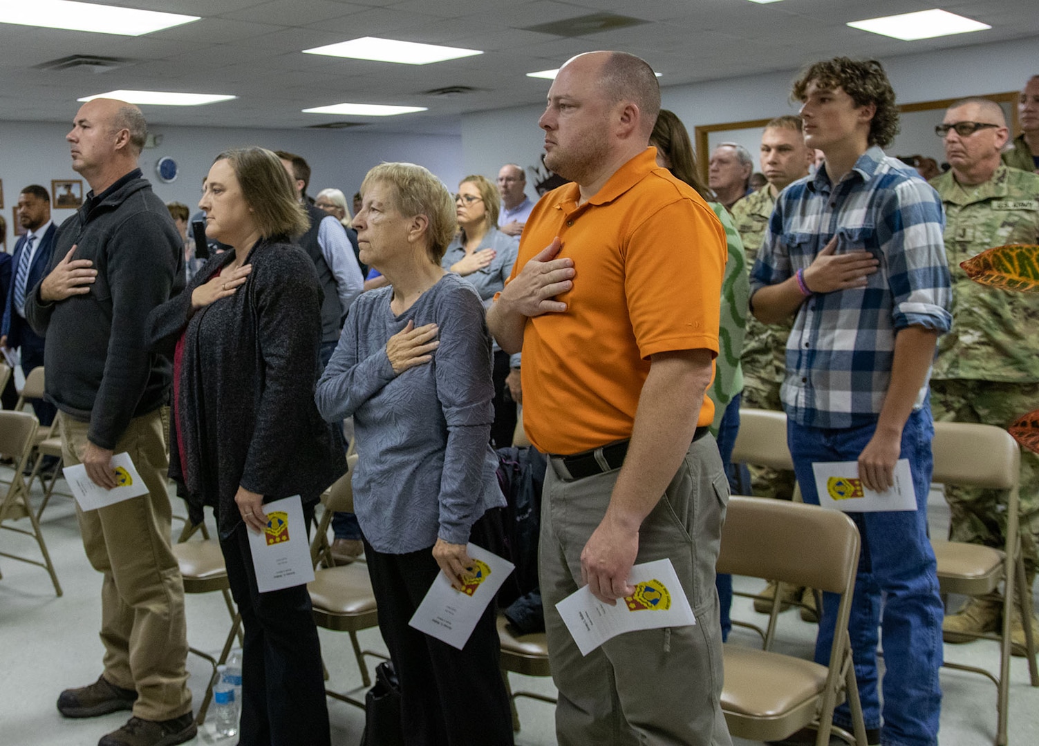 Illinois Army National Guard Spc. Jeremy Ridlen's family, including mother Cheryl, sister Amanda and brother Jason, stand during the national anthem during a ceremony dedicating the Maroa, Illinois post office in honor of Ridlen, Oct. 25 at the Maroa Fire Department.
