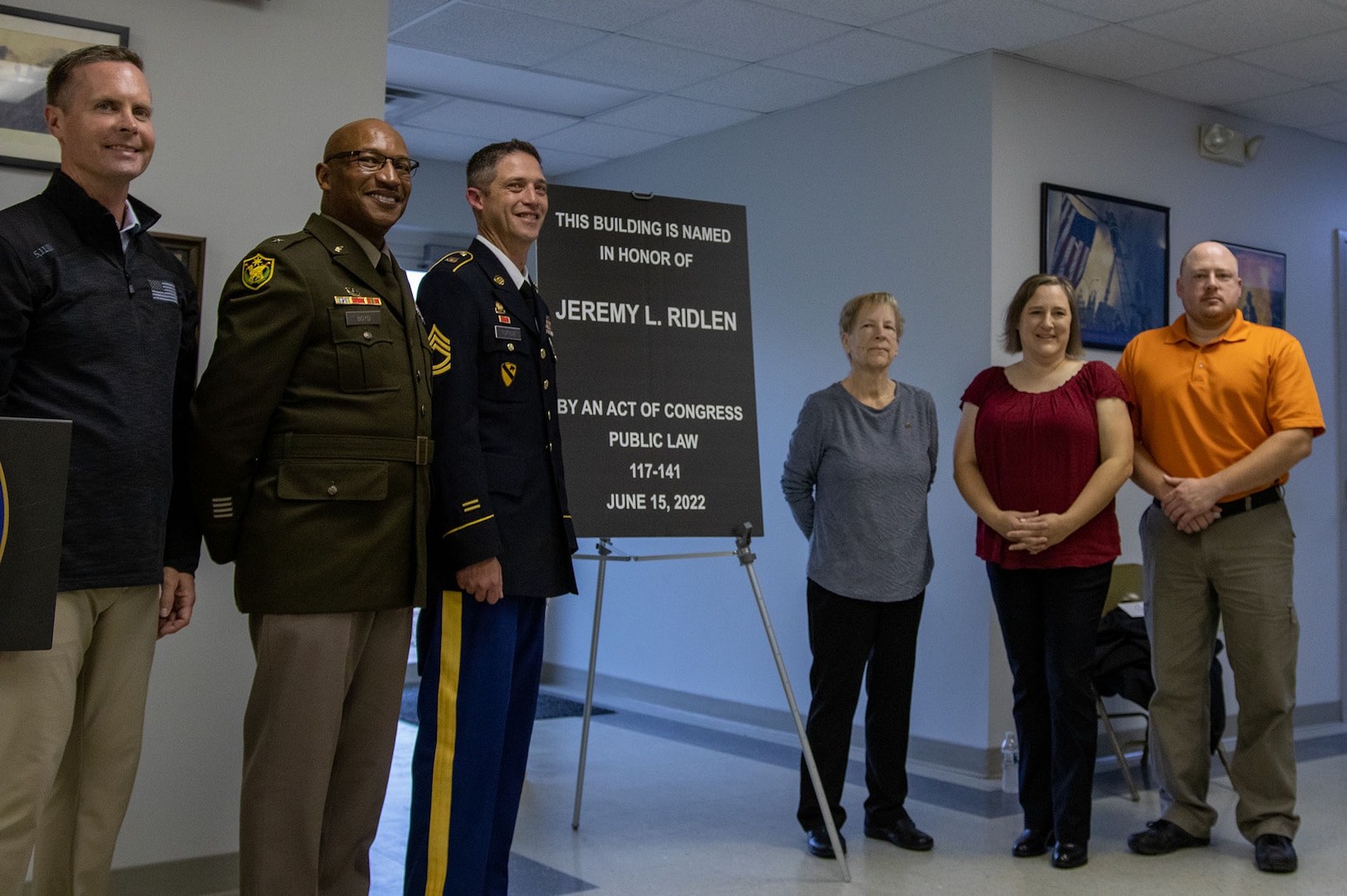 The family of fallen Illinois Army National Guard Spc. Jeremy Ridlen, mother, Cheryl, sister, Amanda and twin brother, Jason, are joined by U.S. Congressman Rodney Davis, Brig. Gen. Rodney Boyd, Assistant Adjutant General – Army and Commander of the Illinois Army National Guard, and Sgt. 1st Class Phillip Tuttle, during the unveiling of the plaque, dedicating the Maroa, Illinois, post office in honor of Ridlen, during a ceremony Oct. 25 at the Maroa Fire Department.