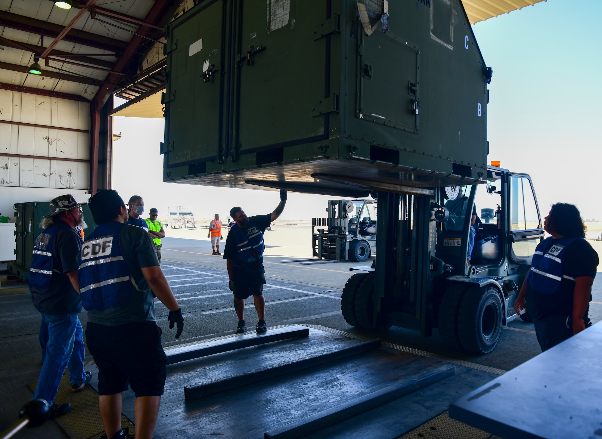 Civilians work together to make sure the cargo is clear of debris