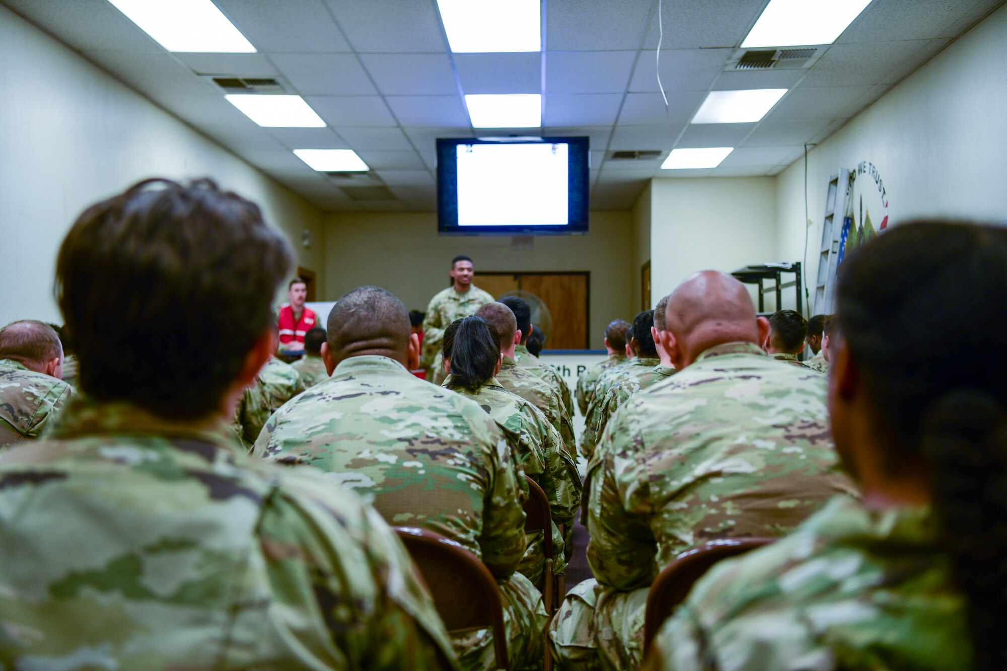 Airmen receive a simulated deployment briefing  during an exercise