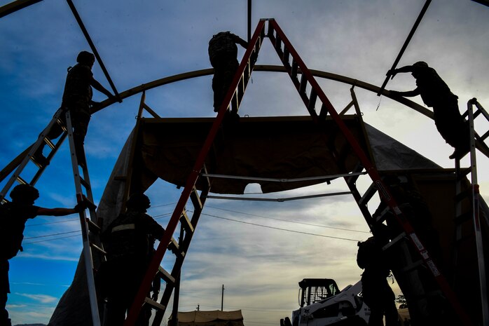 Airmen from the 9th Civil Engineering Squadron work together to build temporary shelters