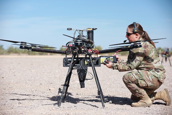Army Staff Sergeant Elise Denning, assigned to Artificial Intelligence Integration Center, conducts maintenance on unmanned aerial system in preparation for Project Convergence
21 at Yuma Proving Ground, Arizona, October 20, 2021 (U.S. Army/Destiny Jones)