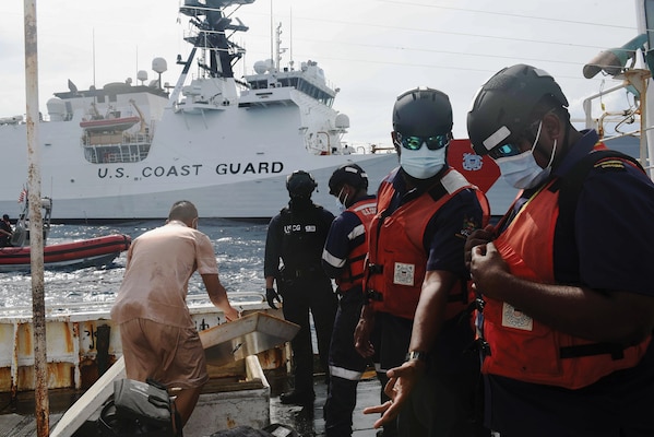 Esira Naidrodro (right), customs officer with Fiji Revenue and Customs Service, and Epironi Turaganivalu (second from right), fisheries assistant with Ministry of Fisheries, Fiji, conduct boarding of China-flagged fishing vessel off coast of Fiji, April
18, 2022, along with other Fijian team members and U.S. Coastguardsmen from USCGC Munro (U.S. Coast Guard/Nate Littlejohn)