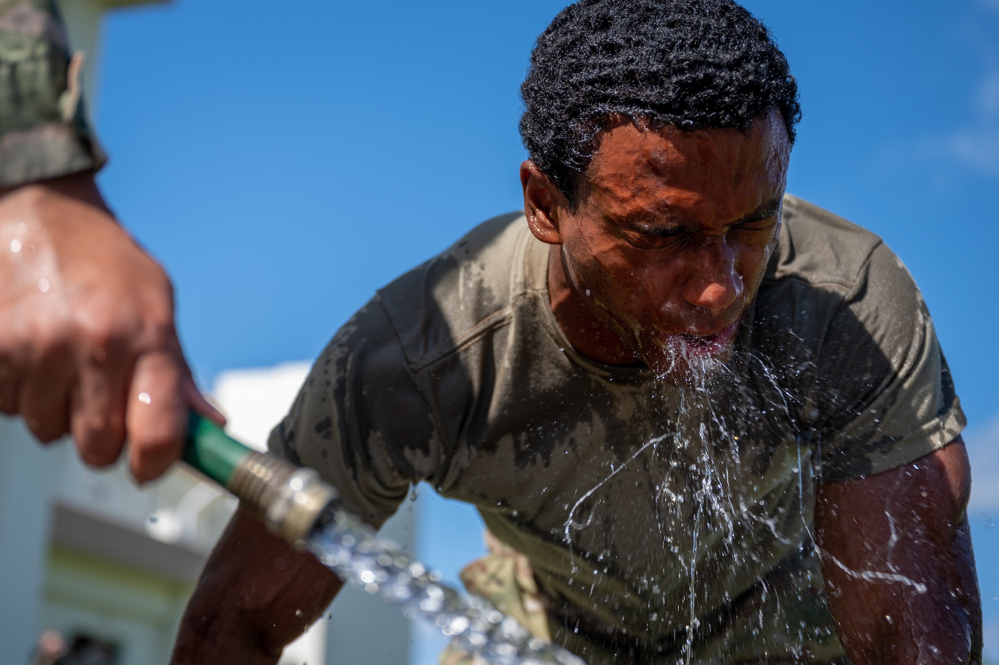 Airman washes face.