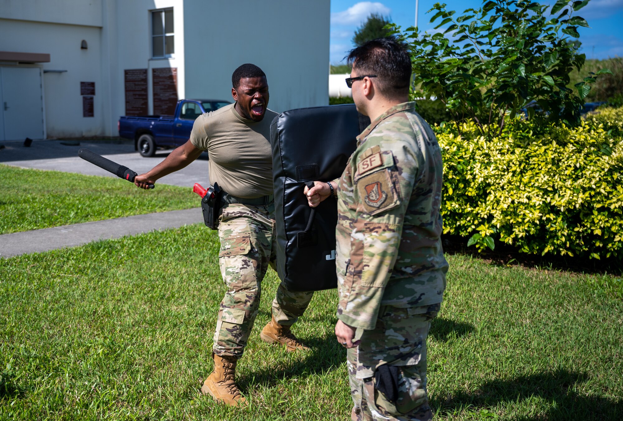 Airman swings baton.