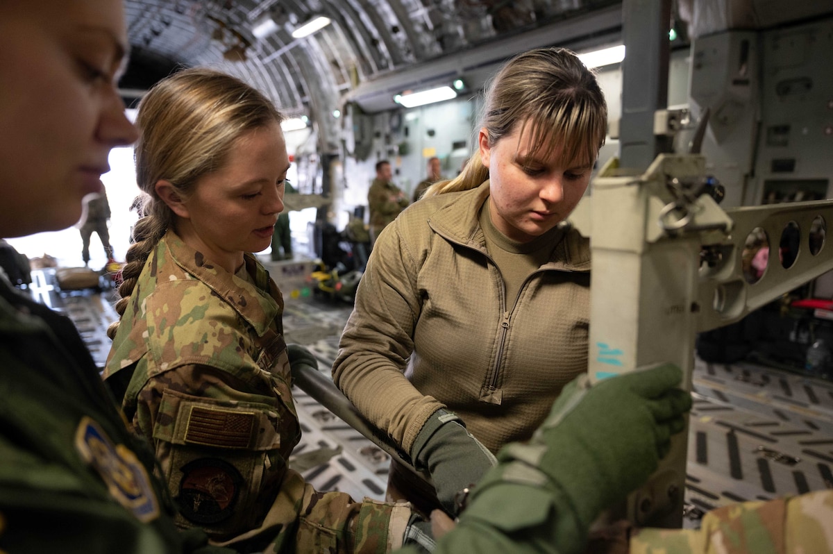 Senior Airman Taylor Sturgell, an aeromedical evacuation technician with the 934th Aeromedical Evacuation Squadron, prepares the C-17 for loading patient litters during an exercise at Minneapolis St. Paul International Airport Air Reserve Station, October 21, 2022. The exercise was planned and executed to test interoperabilty of international joint forces. (U.S. Air Force photo by Master Sgt. Trevor Saylor)