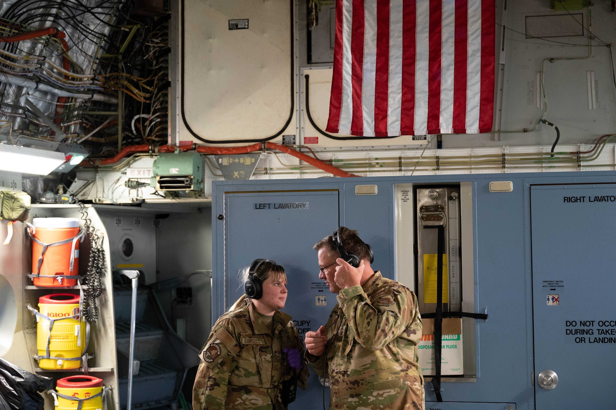Senior Airman Taylor Sturgell, an aeromedical evacuation technician with the 934th Aeromedical Evacuation Squadron, talks to Senior Master Sgt. Zac Johnson, 934 Aeromedical Evacuation Squadron flight instructor, during exercise Winged Serpent, October 22, 2022. The exercise was planned and executed to test interoperabilty of international joint forces. (U.S. Air Force photo by Master Sgt. Trevor Saylor)