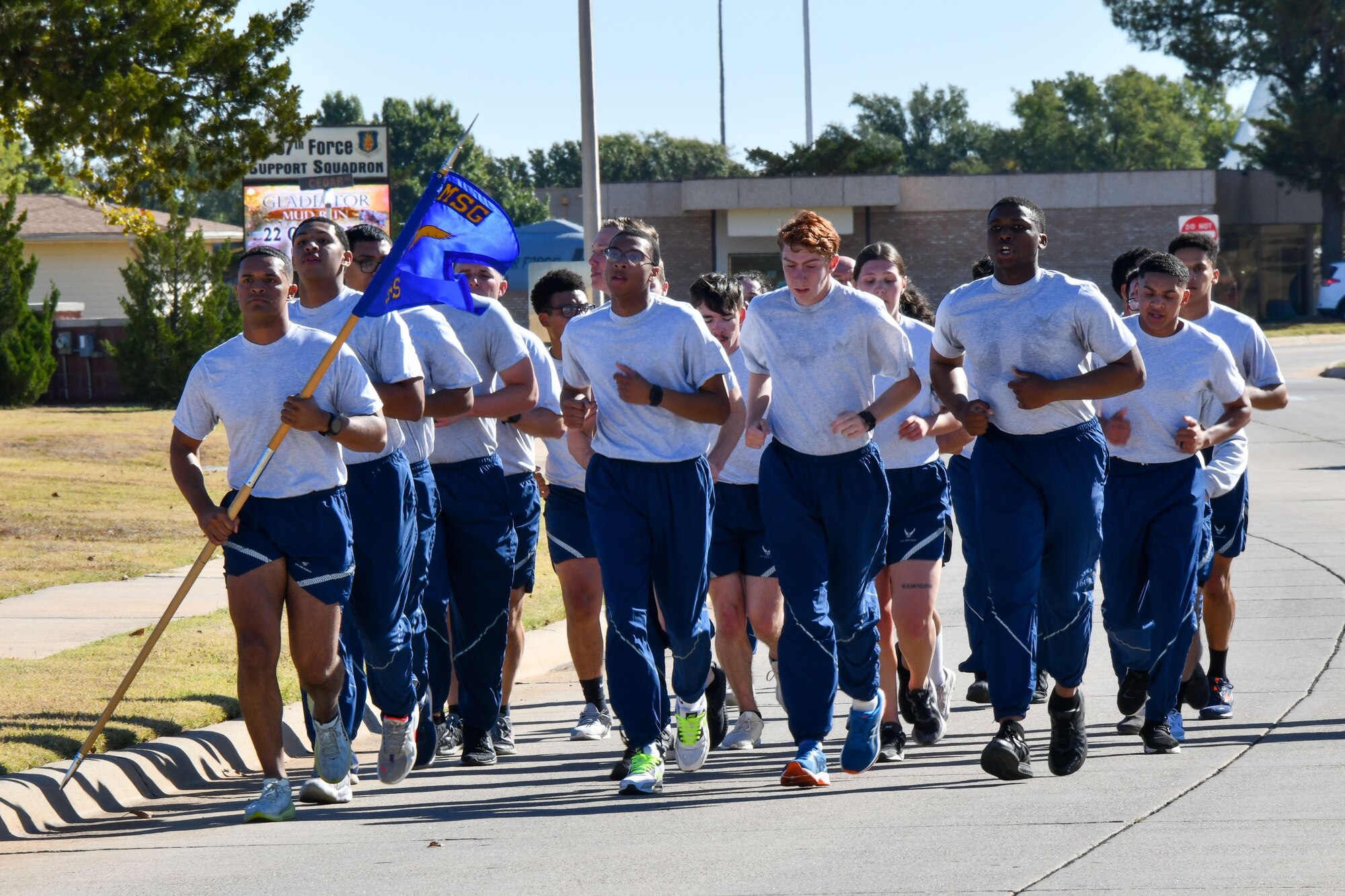 Airmen from the 97th Security Forces Squadron, as well as service members from across the base, finish their 4.5 mile run at Altus Air Force Base (AAFB), Oklahoma Oct. 20, 2022. Prior to starting their run, The Standard team was given a brief slideshow and speech from Melissa Simms, the AAFB historian about the history of Security Forces on AAFB. (U.S. Air Force photo by Airman 1st Class Kari Degraffenreed)