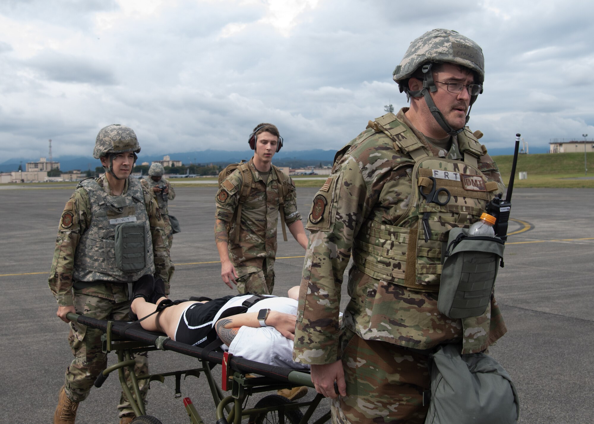 Airmen carry simulated patient on stretcher