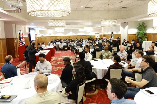 Sean Sackett (Left, standing), chief of the Contracting Division, briefs a presentation during Industry Day, which was held at the Riverbend Golf Course Ballroom, U.S. Army Garrison Humphreys, Oct. 6. The U.S. Army Corps of Engineers Far East District hosted Industry Day to help familiarize attendees with the projected business opportunities and to foster partnerships with industry and understand about its capabilities. The District will take feedback from the event to shape a $400 million Design-Build and Design-Bid-Build Multiple Award Task Order Contract (MATOC), which will be open Korea-wide. (U.S. Army photo by Yo Kyong-il)