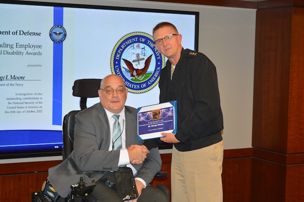 Mr. George Moore (right) Program Analyst for Strategic Systems Programs (SSP) received the Secretary of Defense 2022 Outstanding Civilian with a Disability Award Monday. He was nominated by colleague Martina Sibley (left) who said his accomplishments and commitment to SSP’s core values made him more than worthy of the honor.