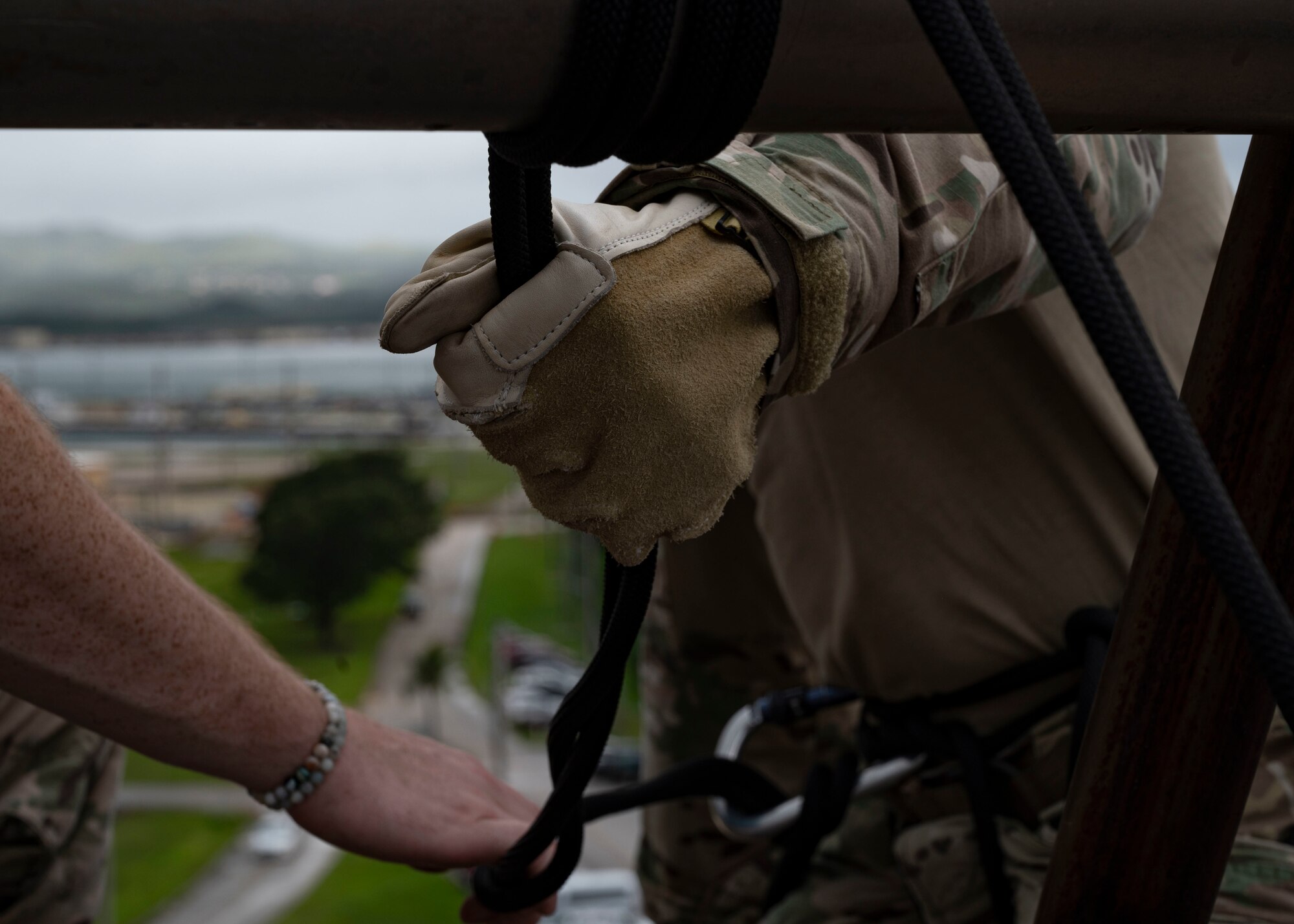 A U.S. Air Force Airman assigned to the 736th Security Forces Squadron, prepares to rappel down a U.S. Navy Explosive Ordinance Disposal Tower on Naval Base, Guam, Oct. 21, 2022. The 736 SFS, 554th Rapid Engineer Deployable Heavy Operational Repair Squadron Engineers and 36th Contingency Response Squadron partook in a training exercise that aimed toward updating and refreshing their skills in rappelling. (U.S. Air Force photo by Airman 1st Class Lauren Clevenger)