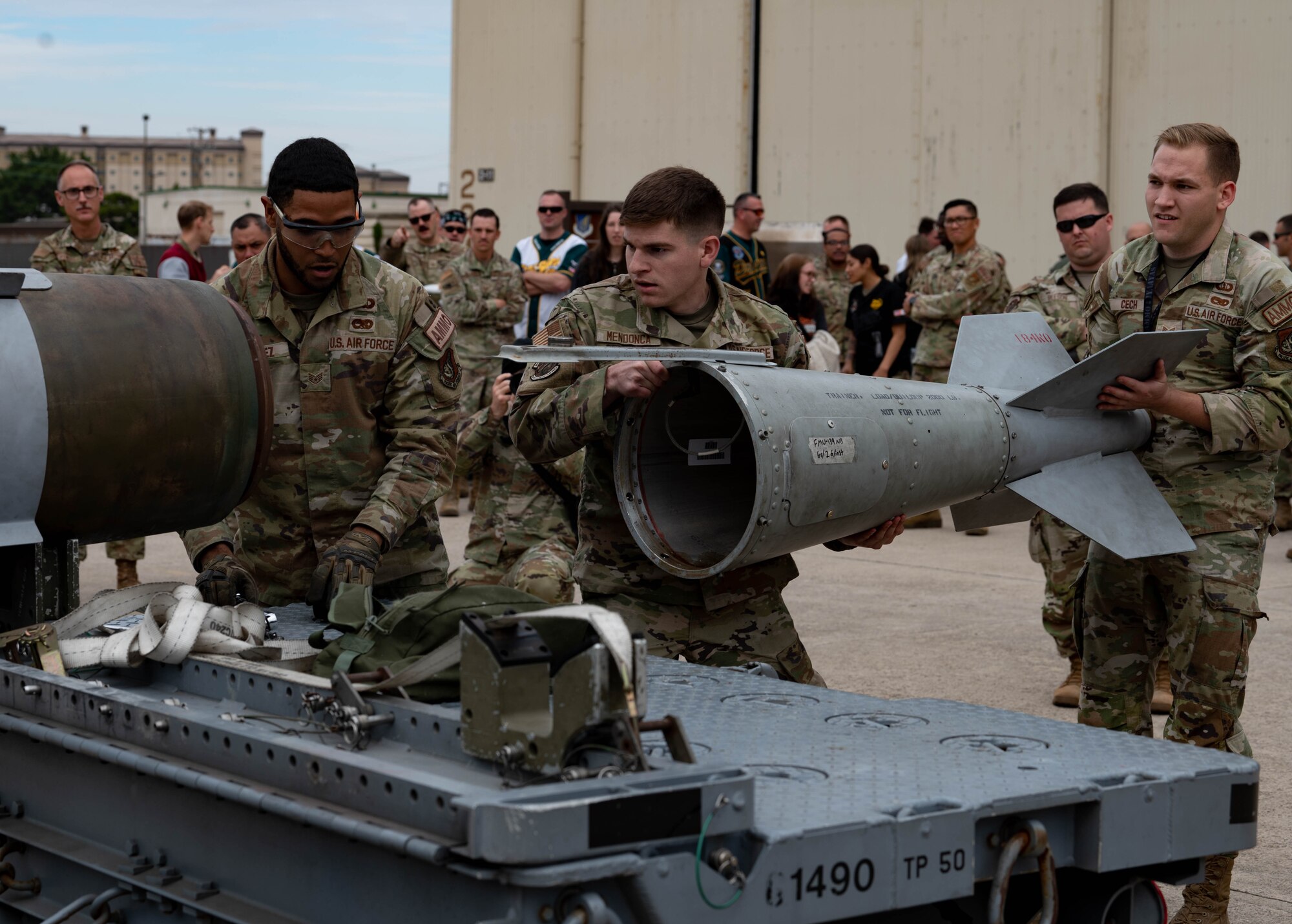 80th Fighter Generation Squadron munitions crew chiefs, assemble a GBU-38 bomb.
