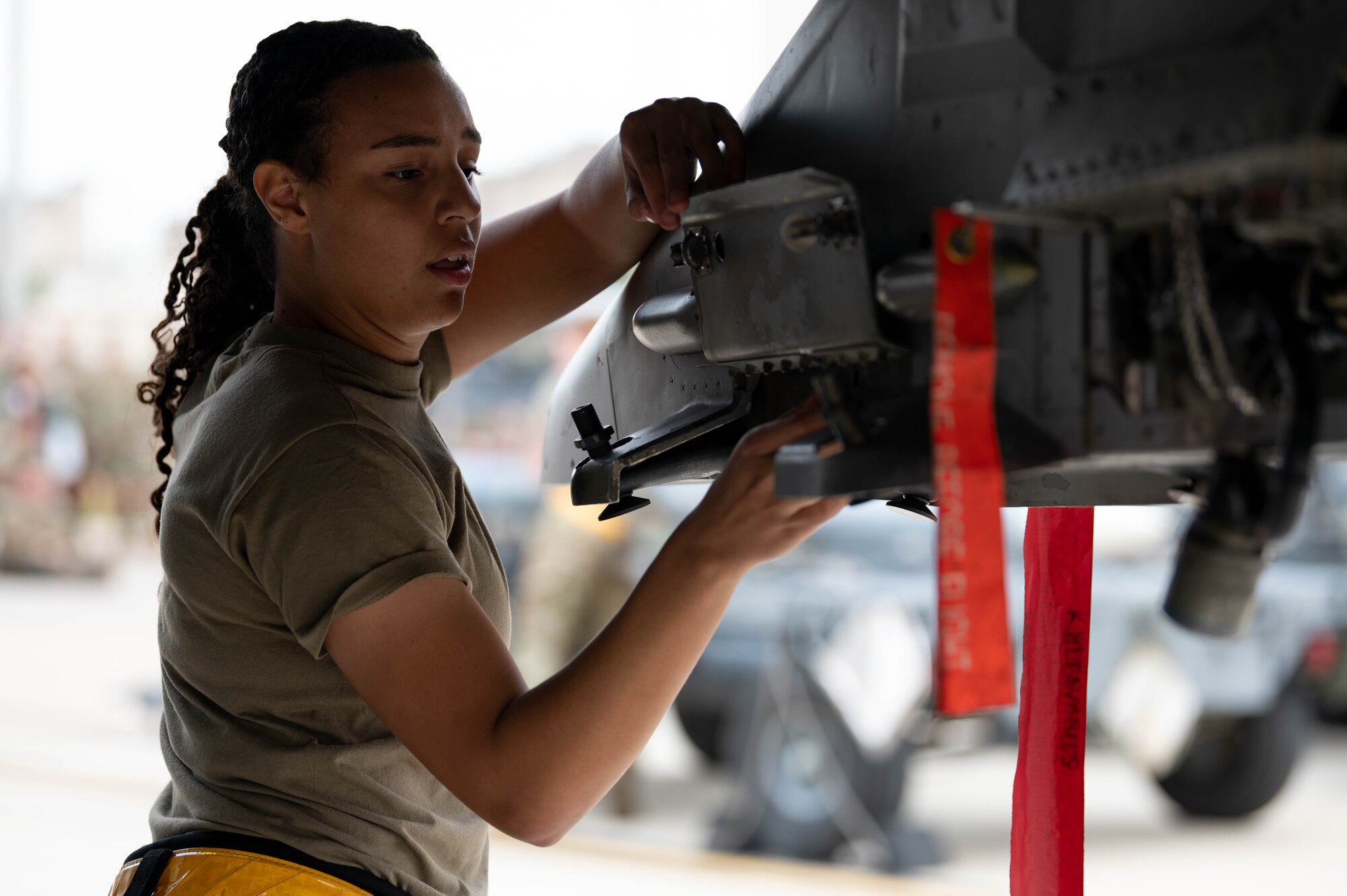 80th Fighter Generation Squadron weapons load crew member prepares a F-16 Fighting Falcon for munitions loading