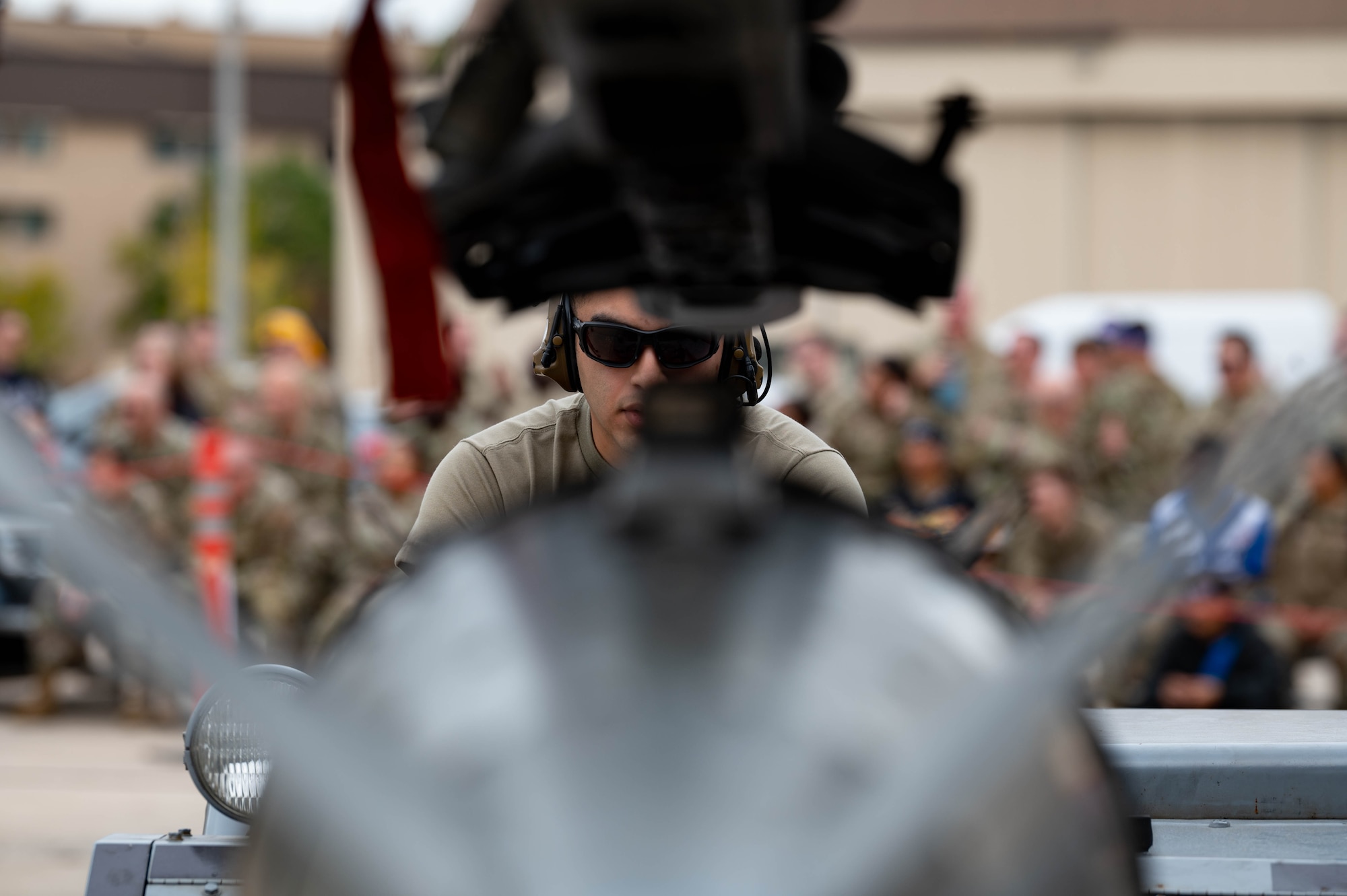 35th Fighter Generation Squadron weapons load crew member, guides a GBU-38