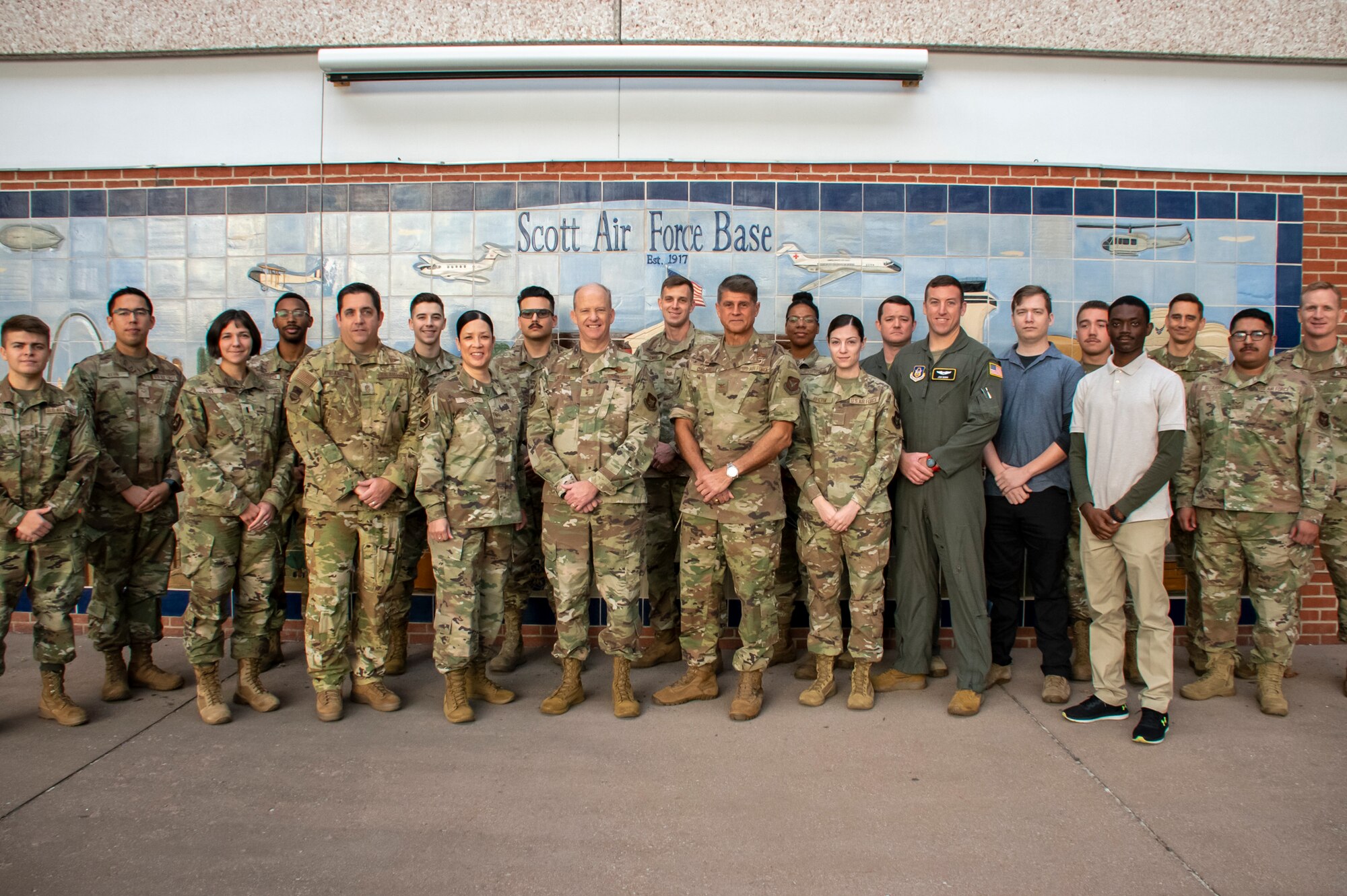 Maj. Gen. Bret Larson, 22nd Air Force commander and Chief Master Sgt. Chin Cox, 22nd Air Force command chief, pose for a photo with new incoming Reserve Citizen Airmen of the 932nd Airlift Wing, Oct. 16, 2022, at Scott Air Force Base, Illinois. While at the 932nd, Larson and Cox met with Citizen Airmen around the wing to discuss how the higher command could best serve them and the importance of bridging the gap between the decision-makers and the Airmen they affect. (U.S. Air Force photo/Senior Airman Jonathan Stefanko)