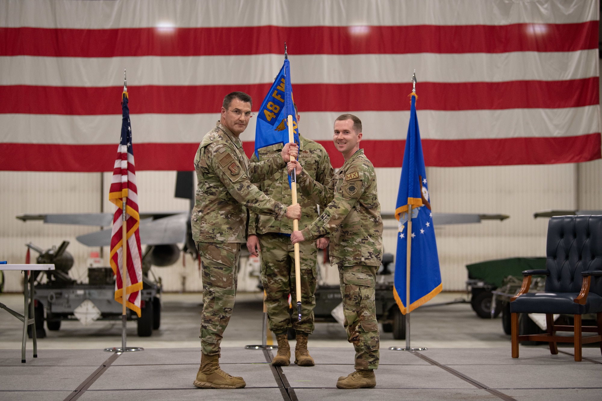 U.S. Air Force Col. Joseph Stangl presents the guidon to Maj. Nathan Stroupe.
