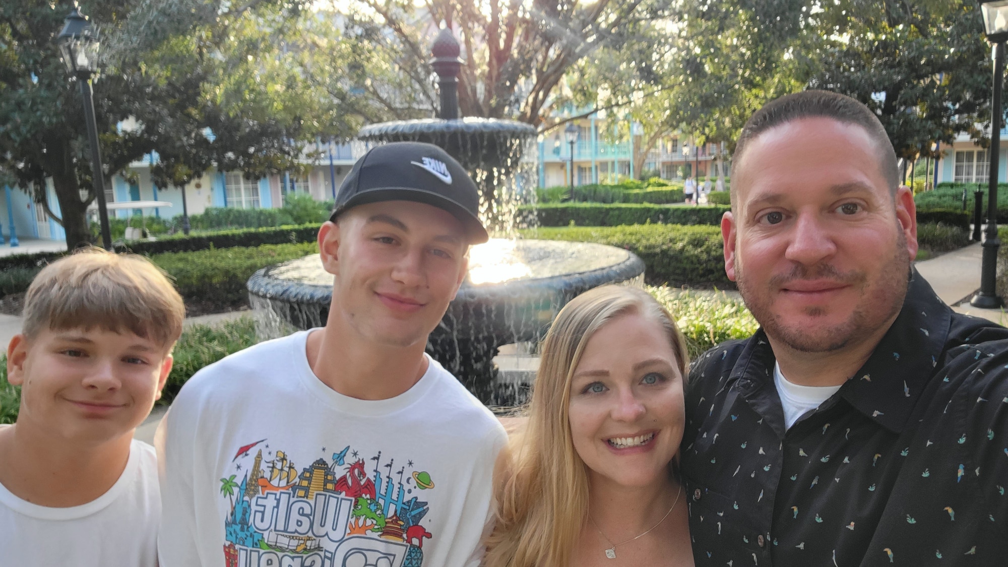 A man and woman pose for a photo with their two sons.