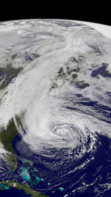 A satellite photo shows a large spiral cloud formation.