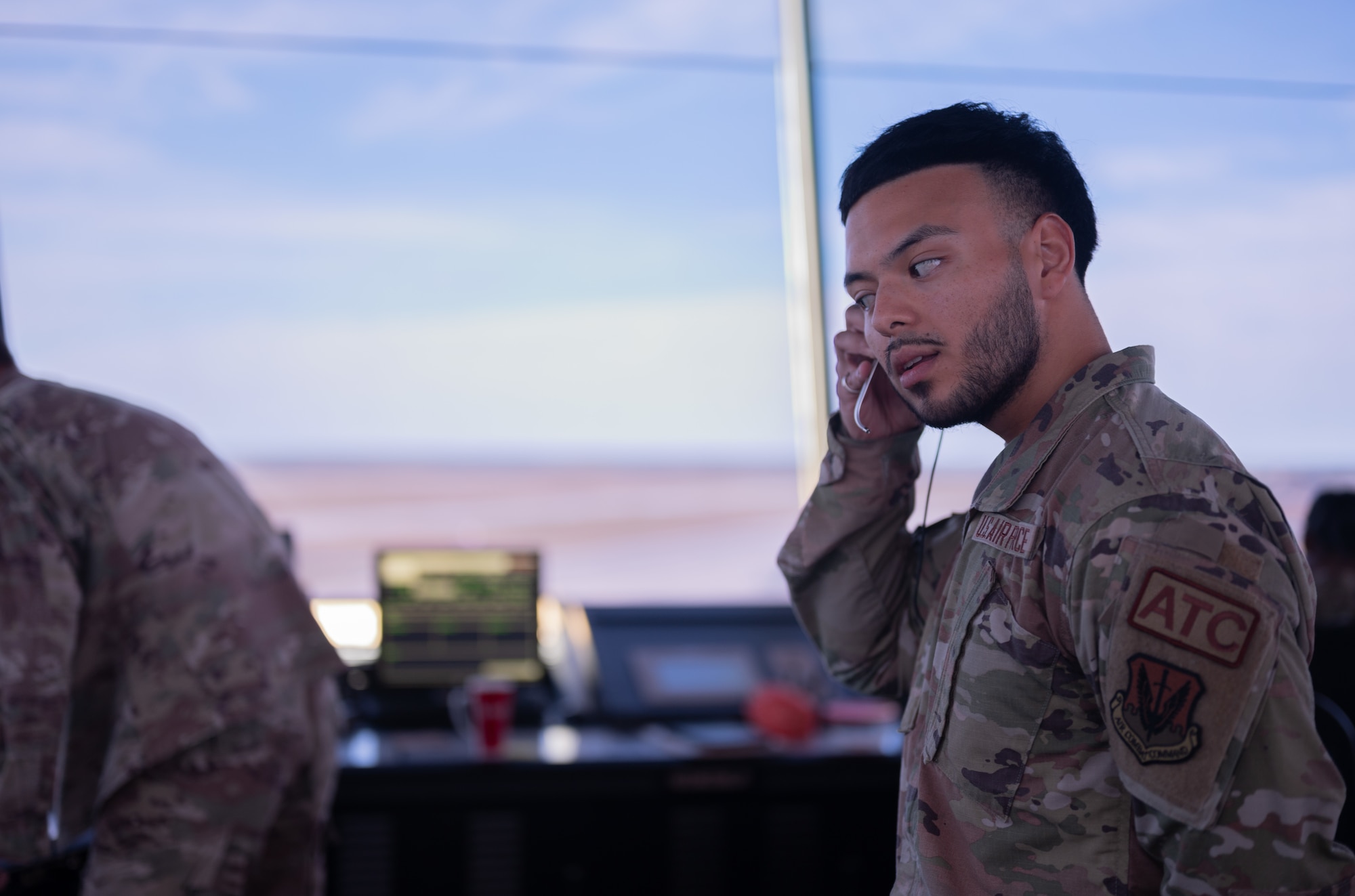 An Airman adjusts his headset in the air traffic control tower at Tyndall Air Force Base.