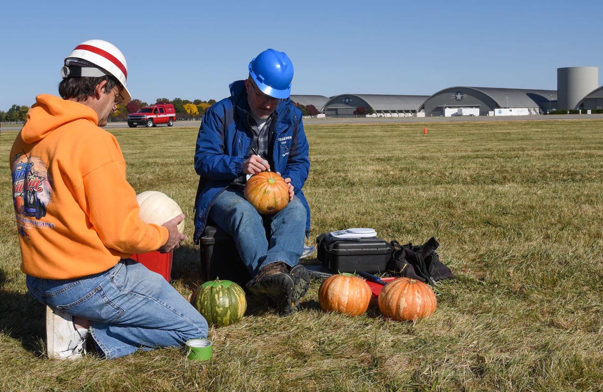 Pumpkin Chuck participants mark pumpkins before launch during the Oct. 15 event at Wright-Patterson Air Force Base, Ohio. Teams competed for top marks in distance and accuracy at the 17th annual event. (U.S. Air Force photo by Airman 1st Class Elizabeth Figueroa)