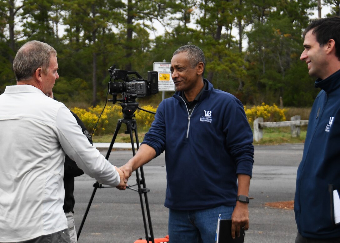 senator shaking hands with members of City of Virginia Beach government in a parking lot