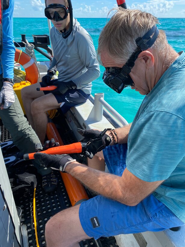 Alexis Catsambis (NHHC) and Bob Neyland (NHHC) prepare to investigate anomalies. While the magnetometer records anomalies, it does not provide a clear visual of the object. Divers or snorkelers are deployed to examine the anomaly and determine its archaeological and historical significance. If any artifacts are exposed, possible dating or identification efforts can follow. If the object is buried, probing or excavation may follow.