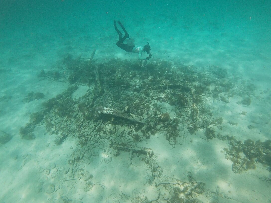 Madeline Roth (NOAA) surveys shallow wreck remains from the survey. Identified during a visual survey, this shipwreck is examined closely by archaeologists. Structural elements, like fasteners and construction materials, are inspected to date and identify the shipwreck. The Florida Keys is rich in shipwrecks and more than a few were encountered during our survey efforts.