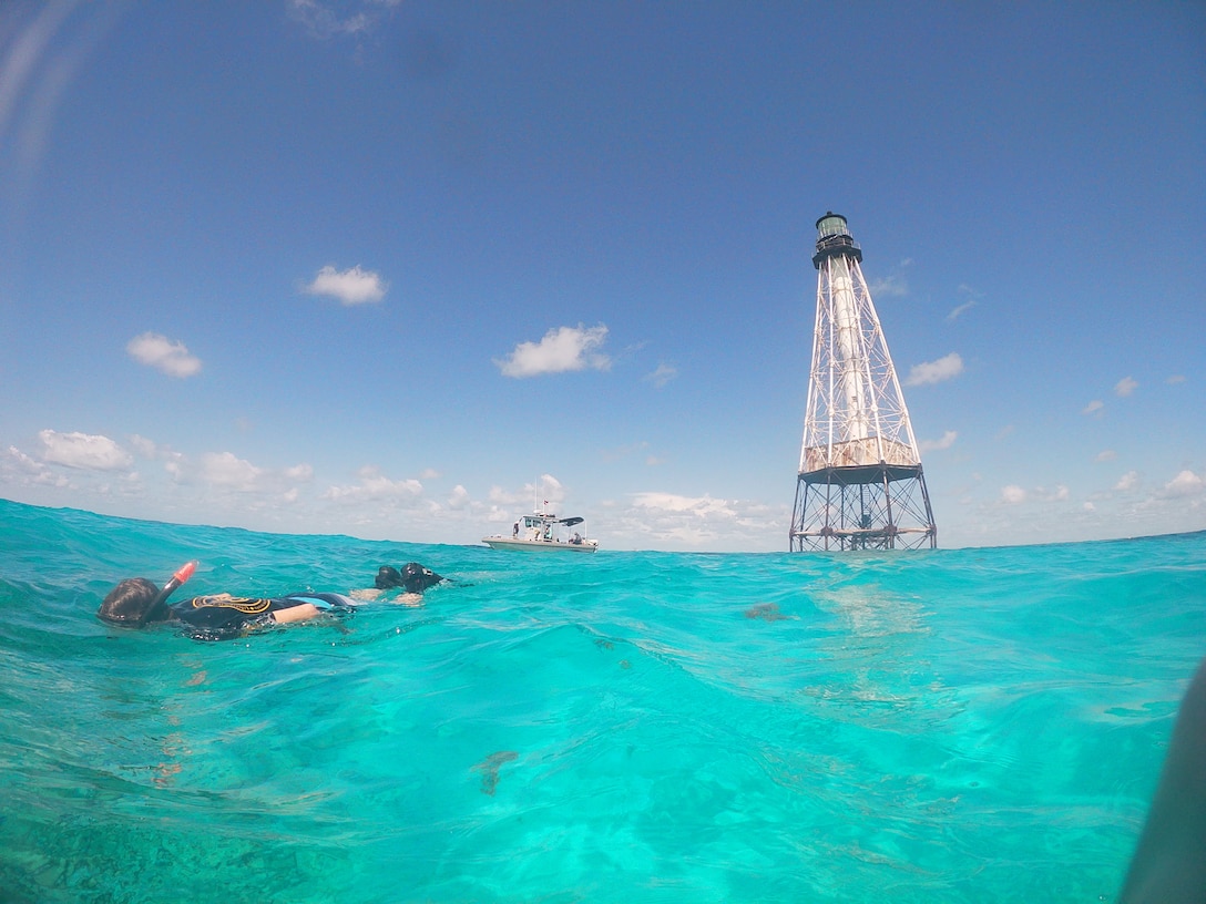 Surveying near Alligator Reef Lighthouse. It was constructed in 1873 and continued service until 2014. The structure marks the nearby reef system that caused several shipwrecks prior to its construction. It is named for Alligator, which may have wrecked in the vicinity of the lighthouse.