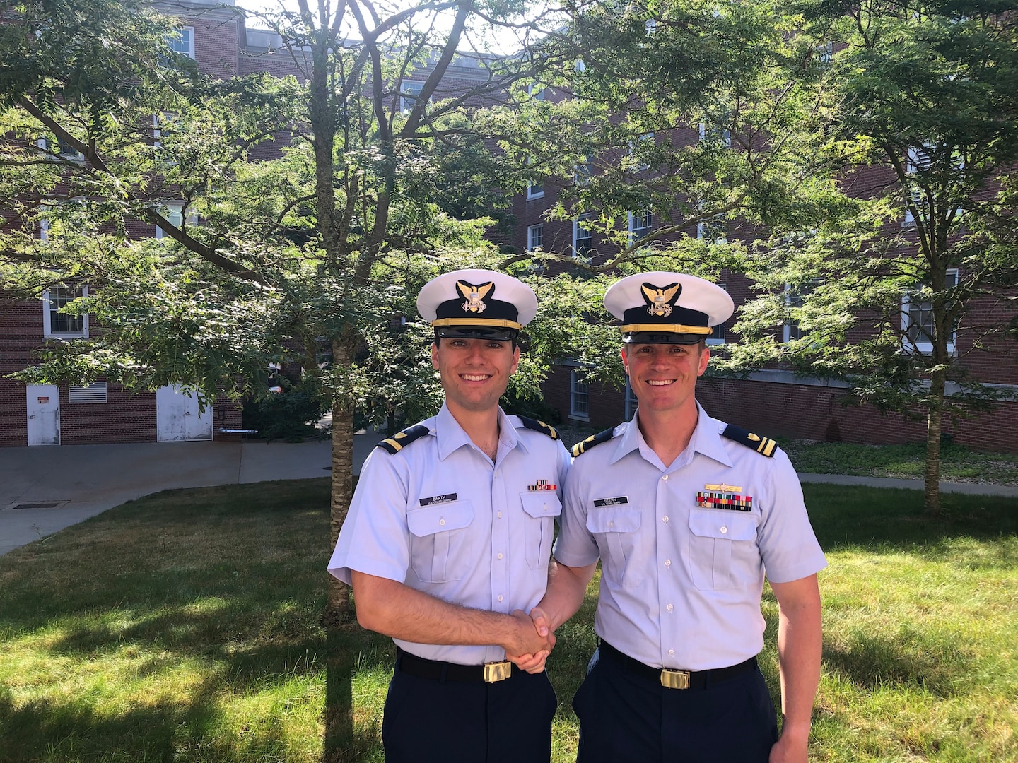 Lt.j.g, Benjamin Stern shakes Ensign Michael Barth’s  hand, July 6, 2022. Stern served as Barth’s assistant Platoon Officer throughout Reserve Officer Candidate Indoctrination. (Courtesy photo by Ensign Michael Barth)